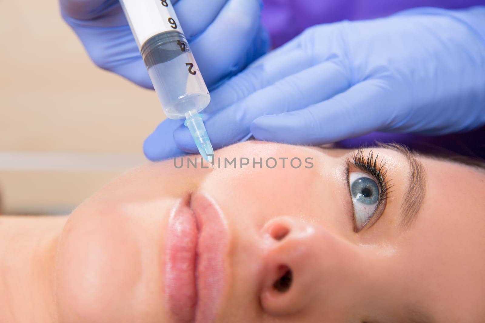 Anti aging facial mesotherapy with syringe closeup  on woman face