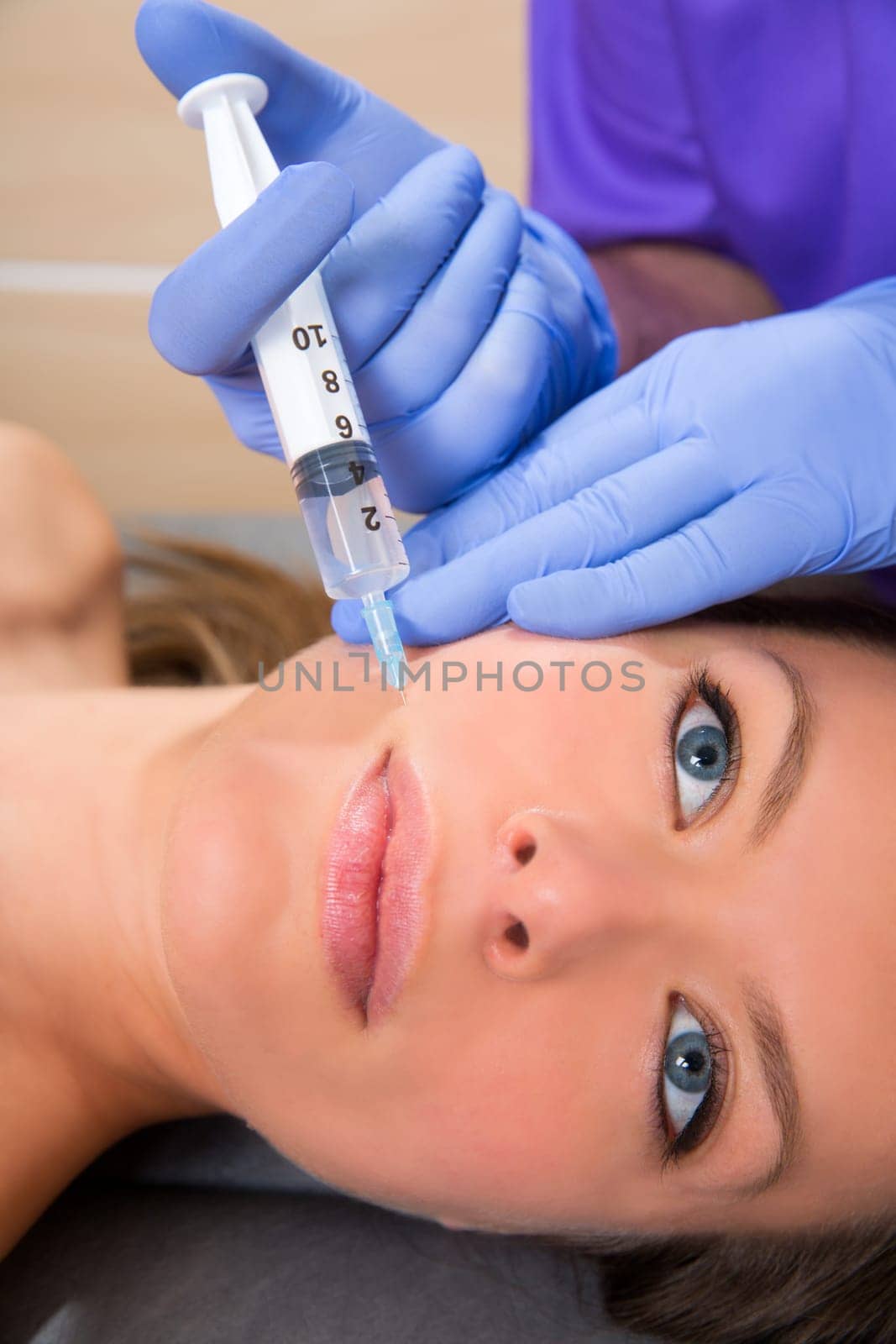 Anti aging facial mesotherapy with syringe closeup  on woman face