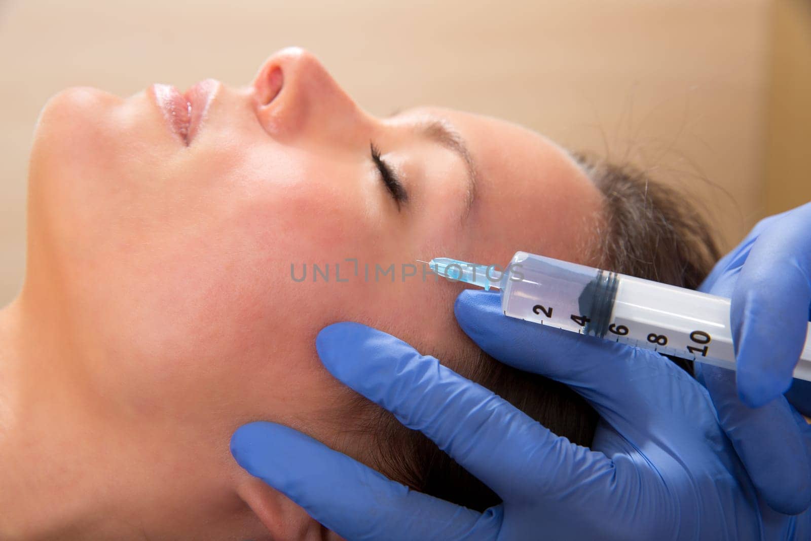 Anti aging facial mesotherapy with syringe closeup  on woman face
