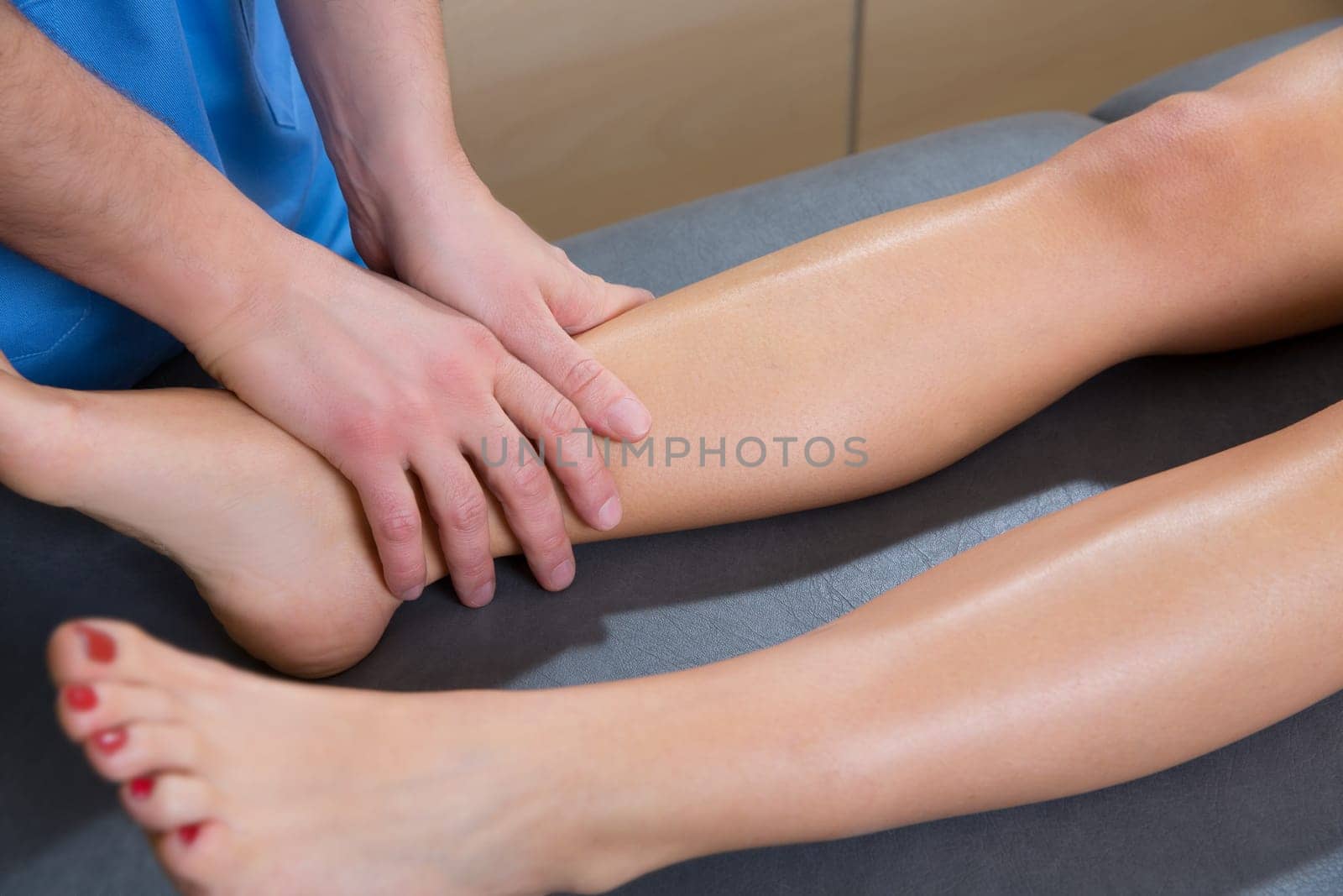 lymphatic drainage massage therapist hands on woman leg ankle