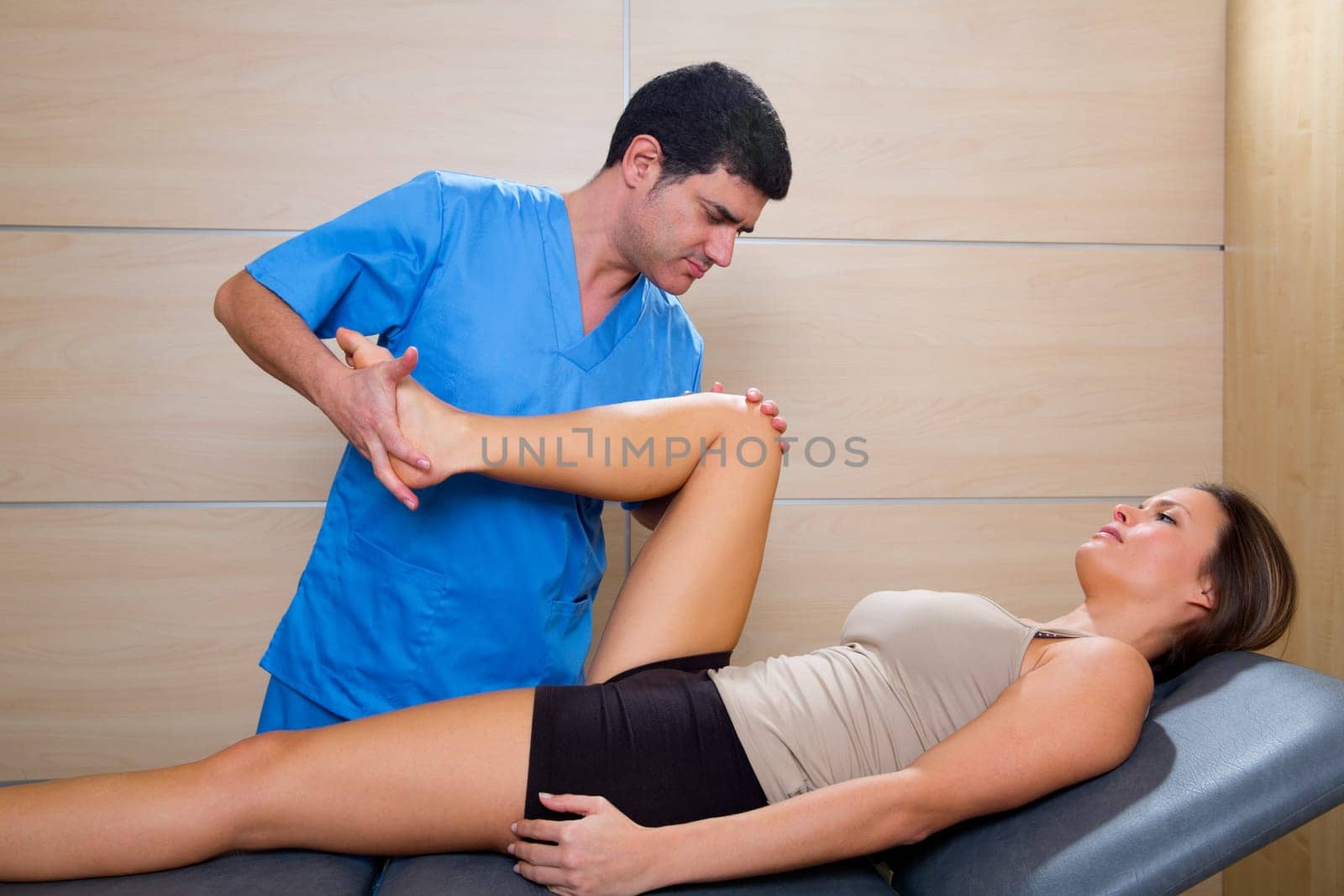hip mobilization therapy by physiotherapist in hospital to beautiful woman