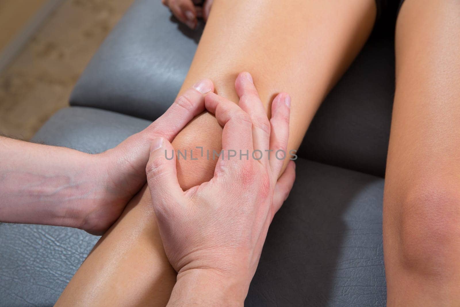 Maitland knee therapy massage on woman leg by therapist hands