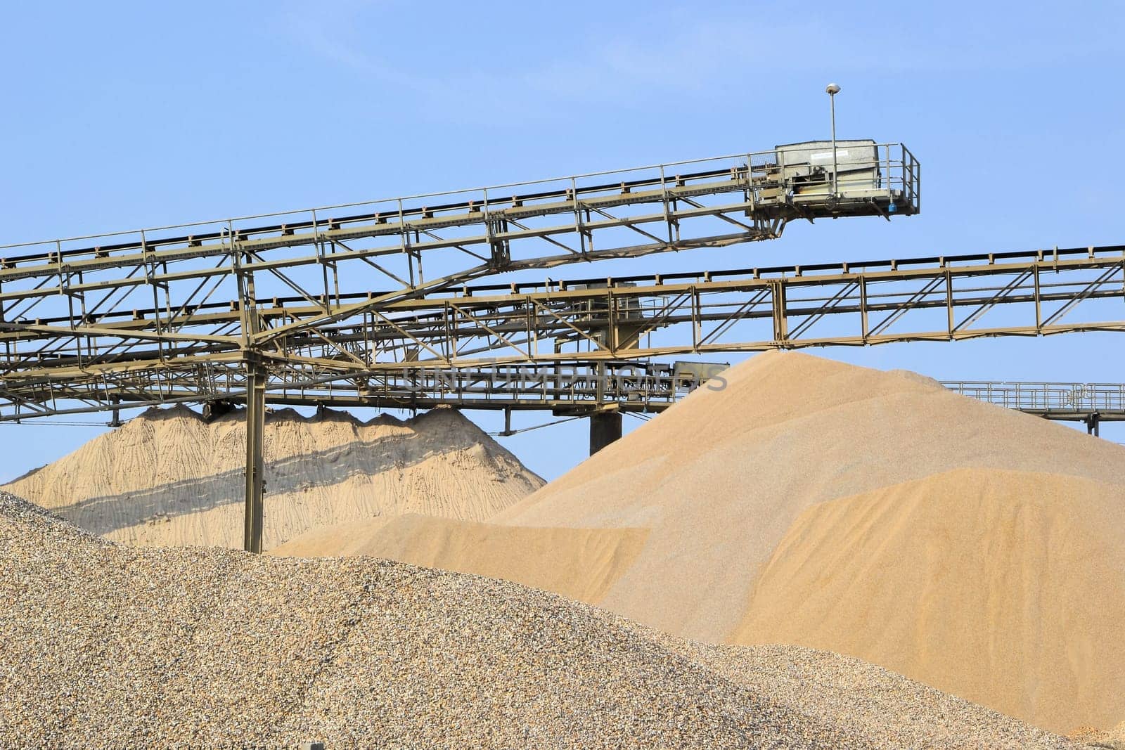 Mountains of gravel and sand in the gravel plant