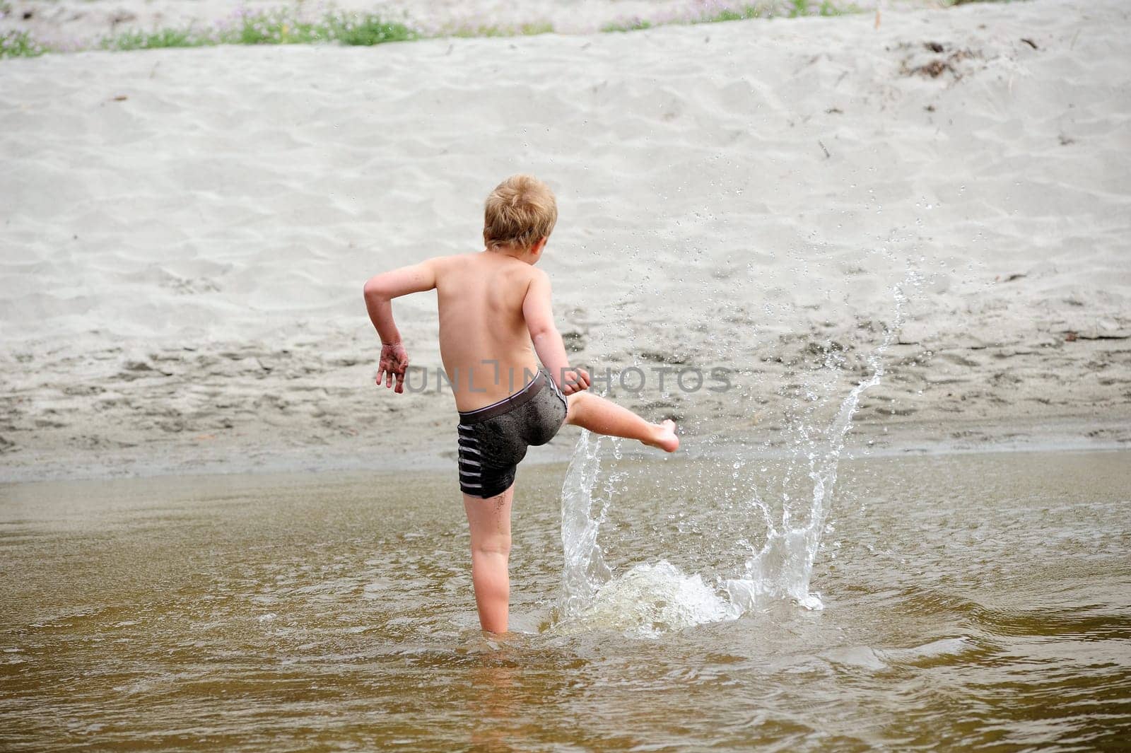 boy is playng in water