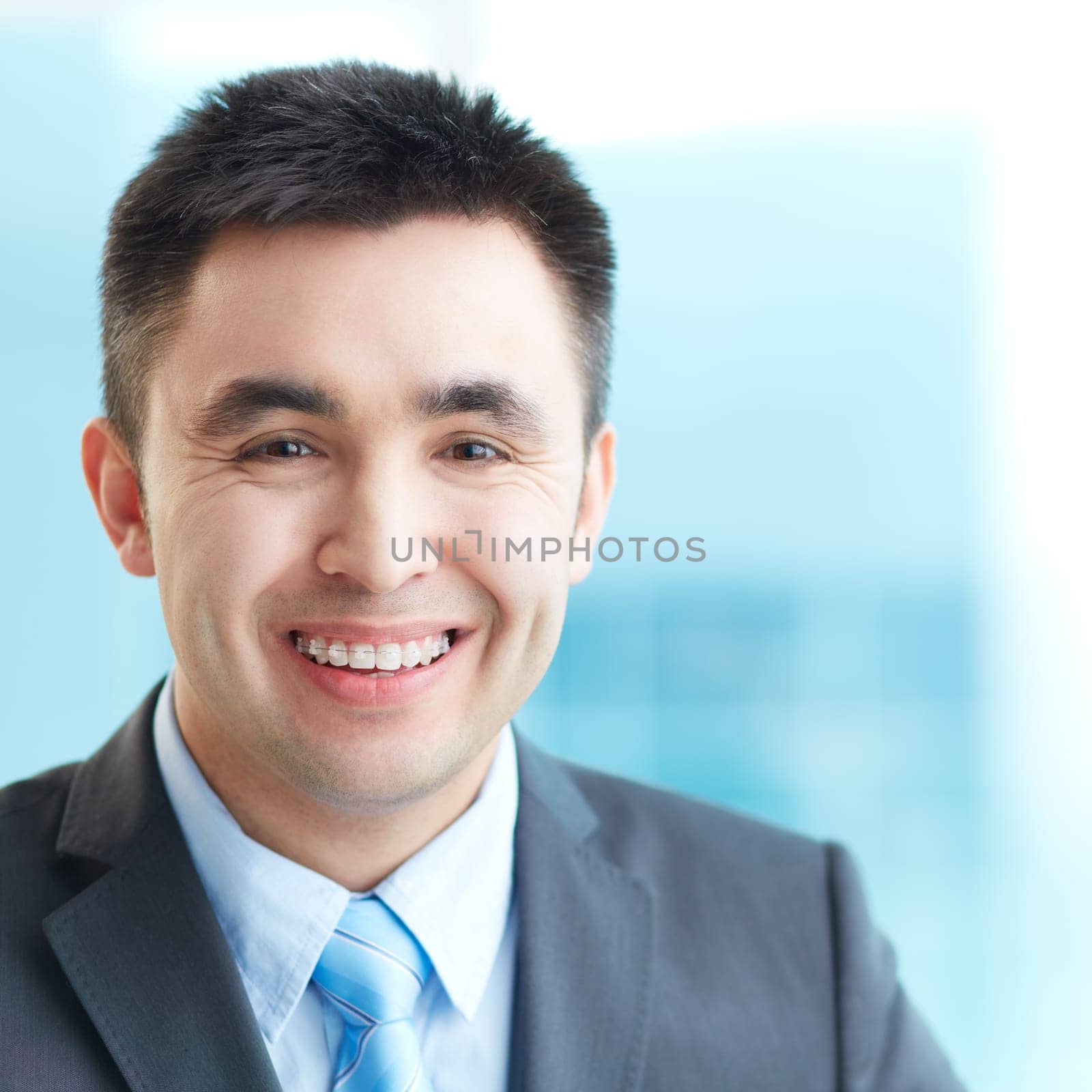 Portrait of cheerful businessman looking at camera with smile