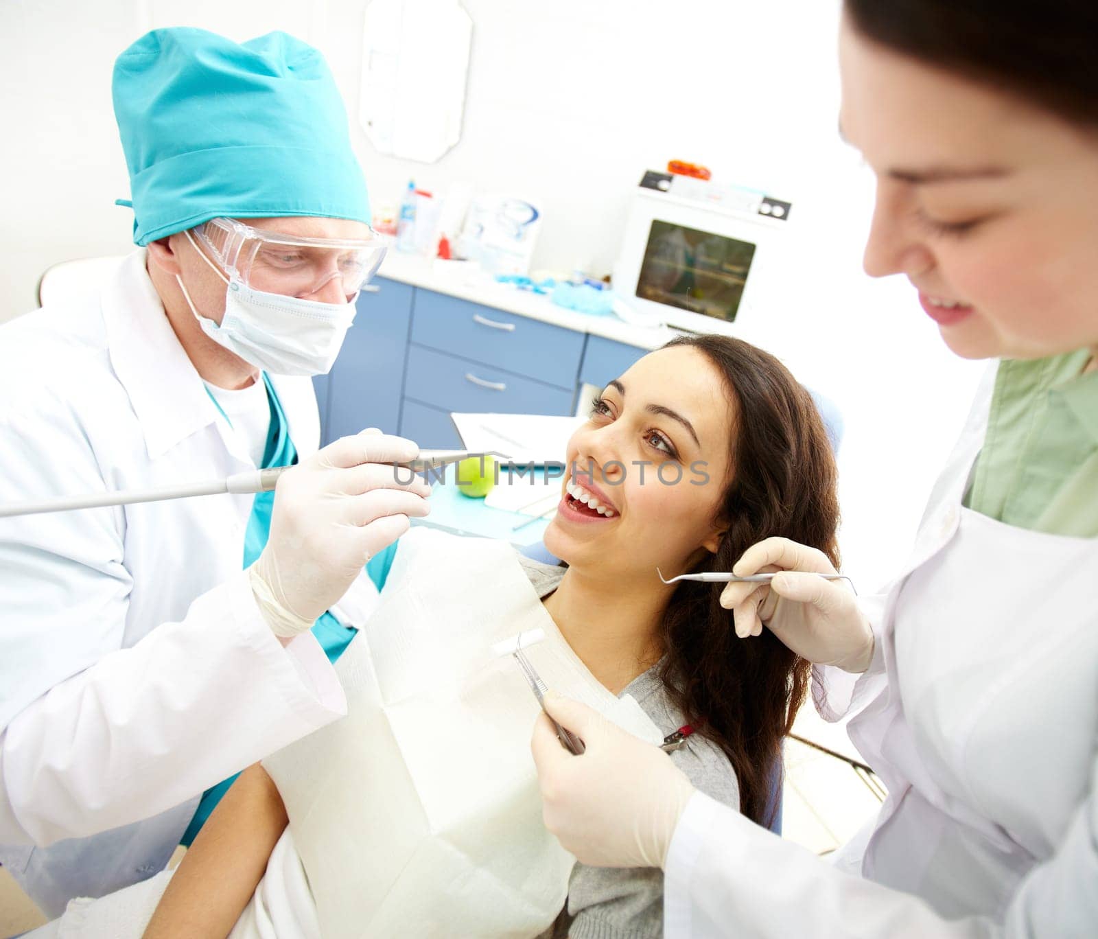 Pretty girl sitting at the dentists and having mouth checkup