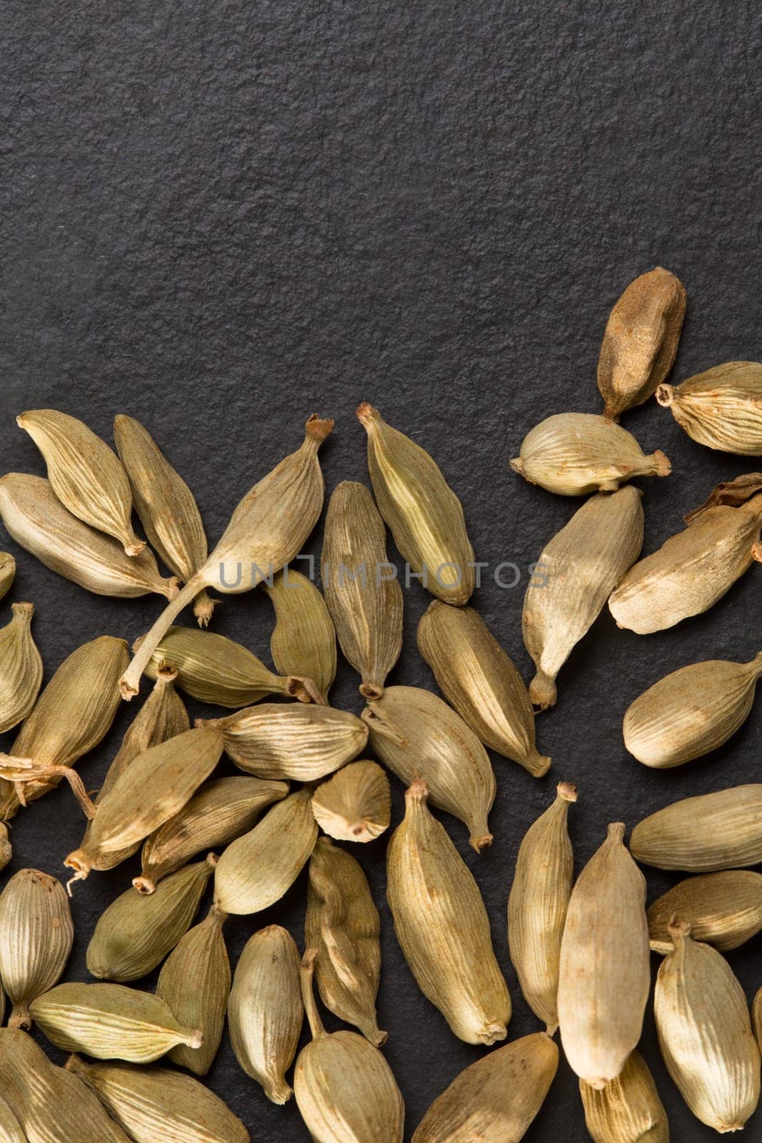 cardamom pods on black background macro closeup