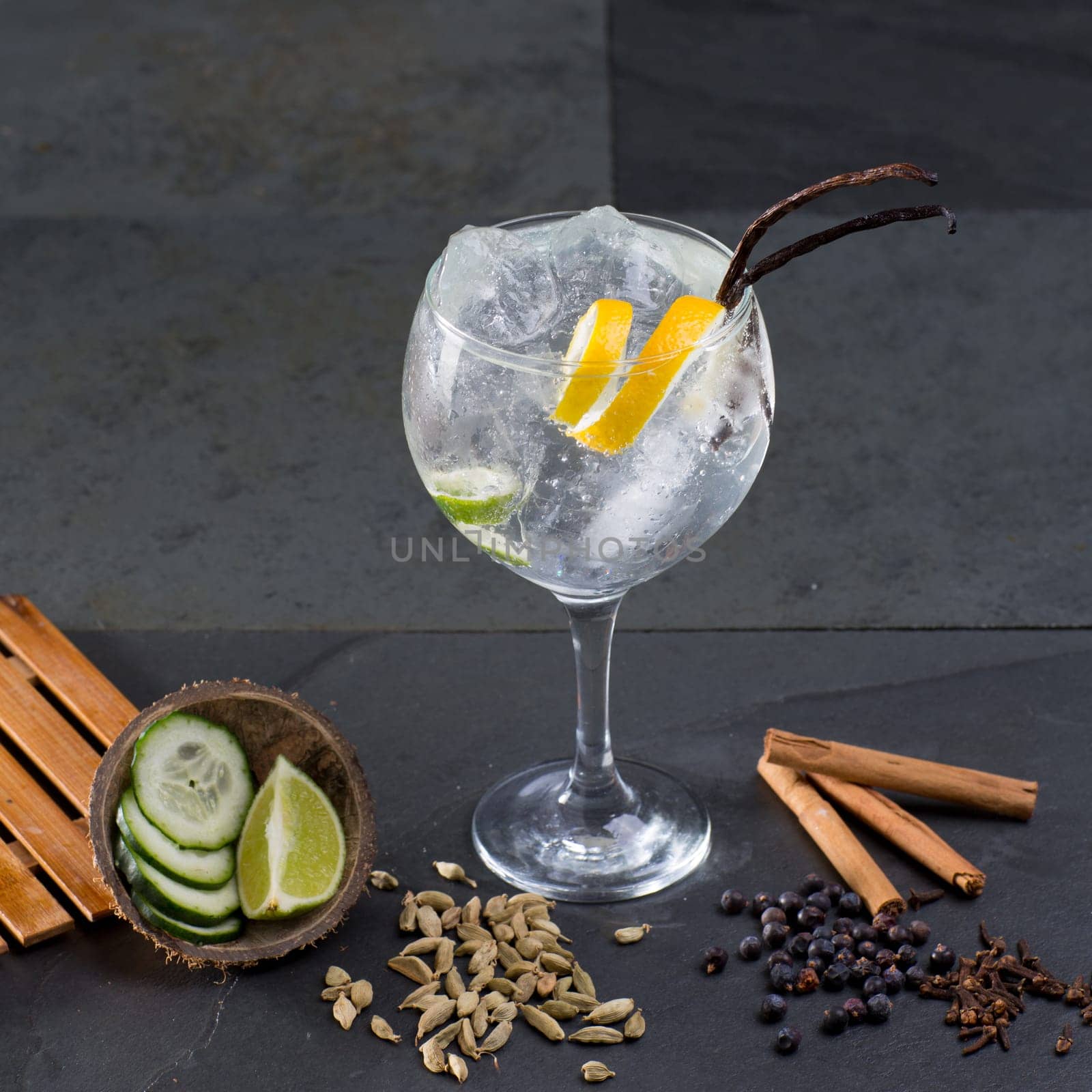 Gin tonic cocktail with lima cucumber vanilla cloves cardamom cinnamon and juniper berries