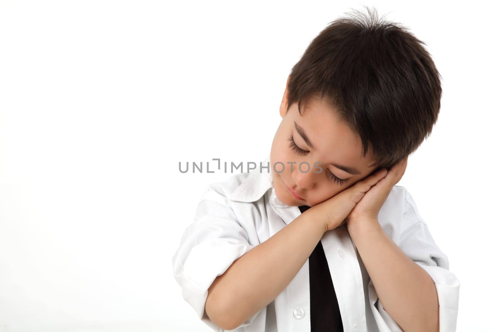 Young boy in studio acting sleeping
