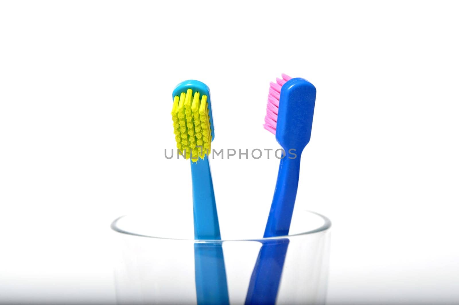 Colorful toothbrushes in a glass