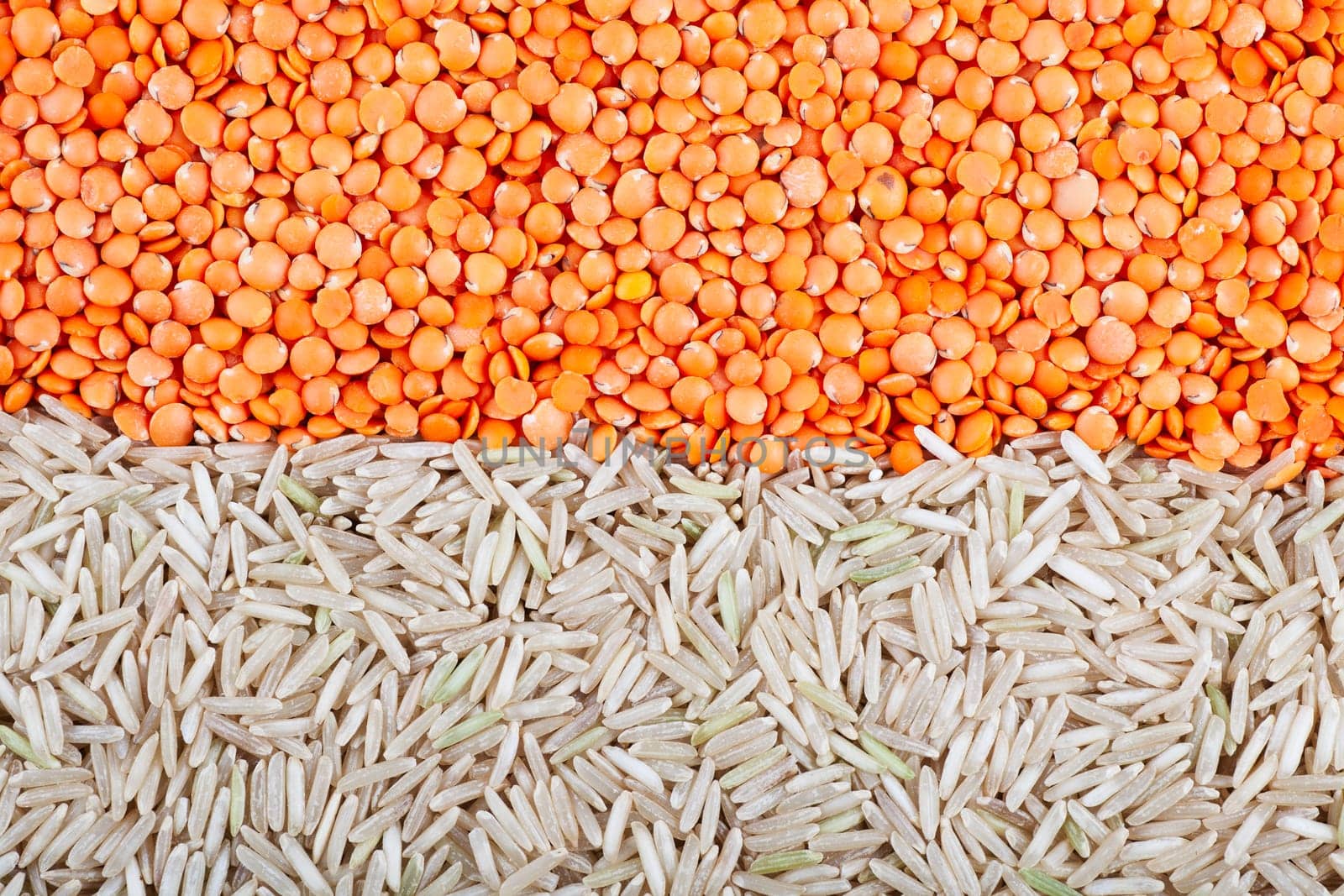 Food background with red lentils and brown basmati rice.
