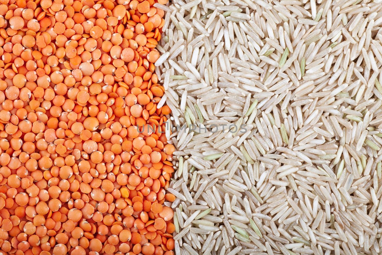 Food background with red lentils and brown basmati rice vertical orientation.