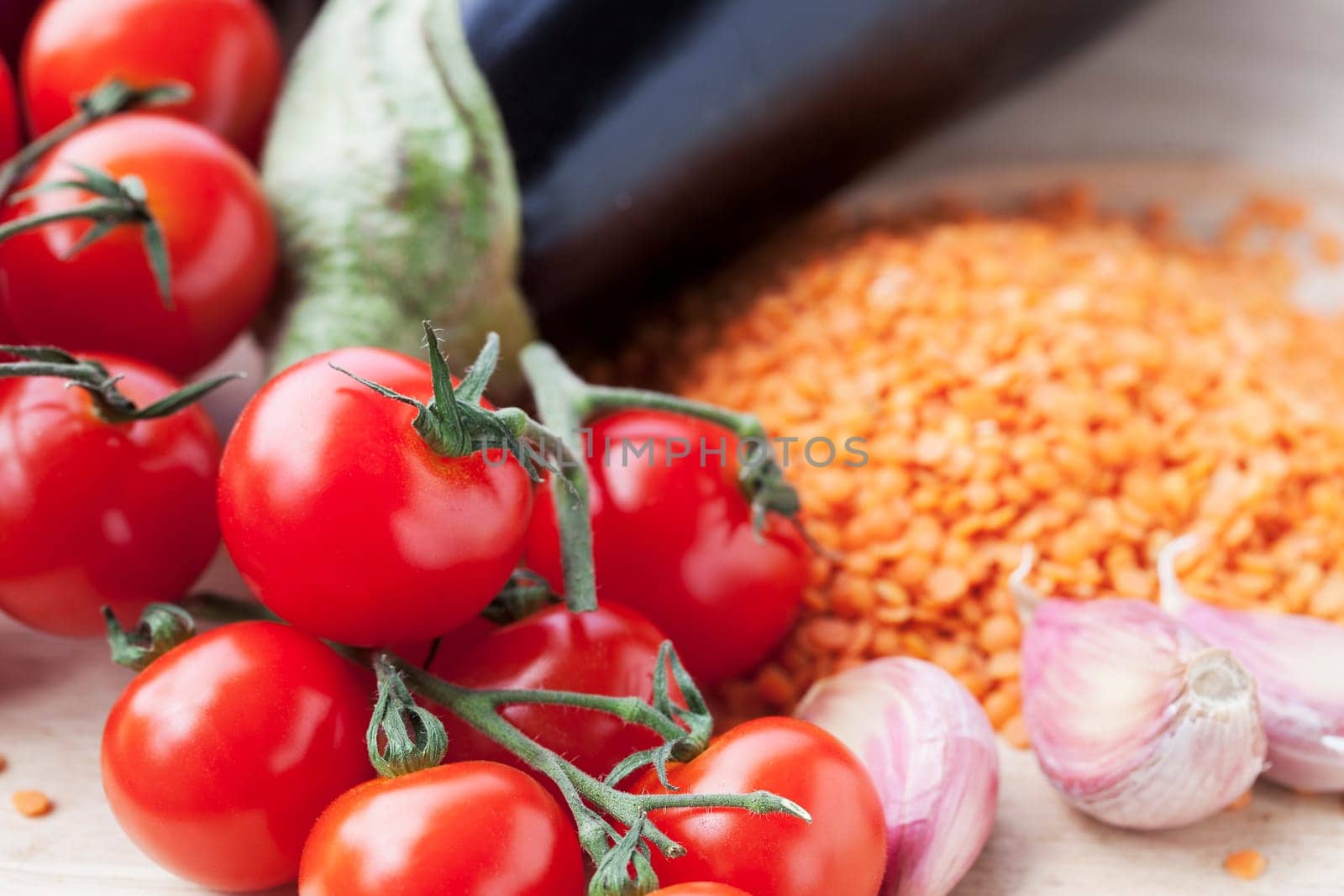 Ingredients for red lentil curry with aubergine and cherry tomatoes.