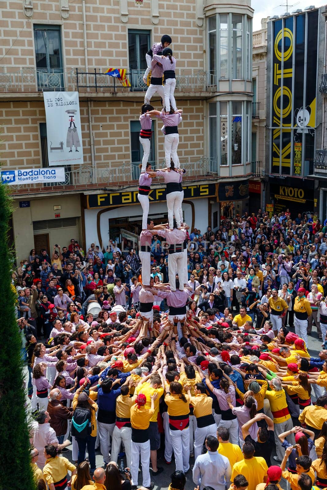 BARCELONA, SPAIN - MAY 19: Some unidentified people called Castellers do a Castell or Human Tower, typical tradition in Catalonia, on May 19, 2013 in Barcelona, Spain.