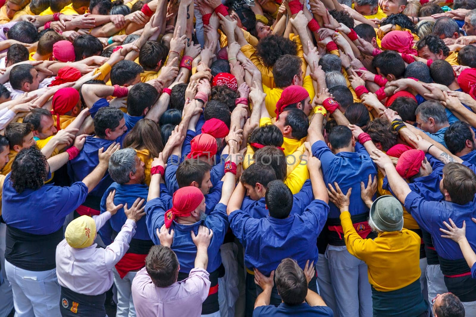 BARCELONA, SPAIN - MAY 19: Some unidentified people called Castellers do a Castell or Human Tower, typical tradition in Catalonia, on May 19, 2013 in Barcelona, Spain.