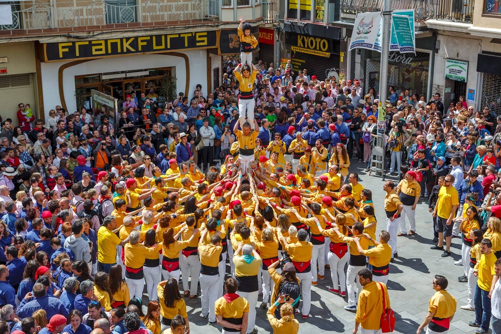 BARCELONA, SPAIN - MAY 19: Some unidentified people called Castellers do a Castell or Human Tower, typical tradition in Catalonia, on May 19, 2013 in Barcelona, Spain.
