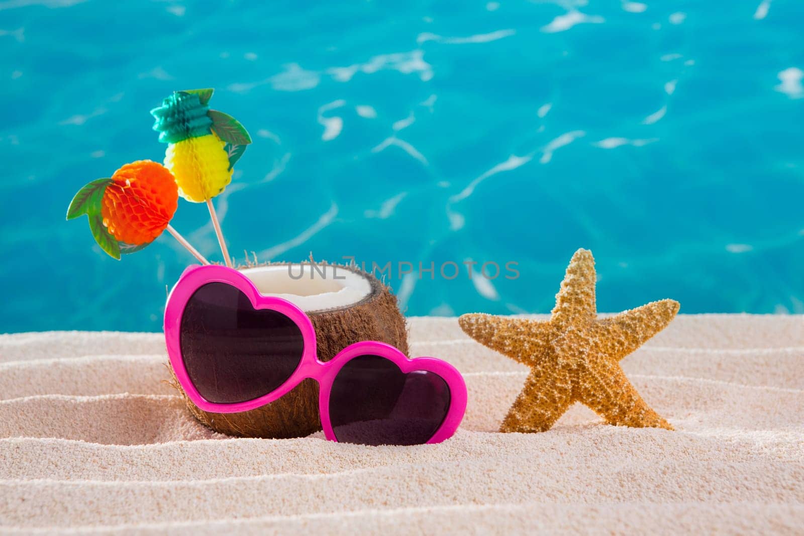 Coconut cocktail on tropical white sand beach heart shape funny sunglasses