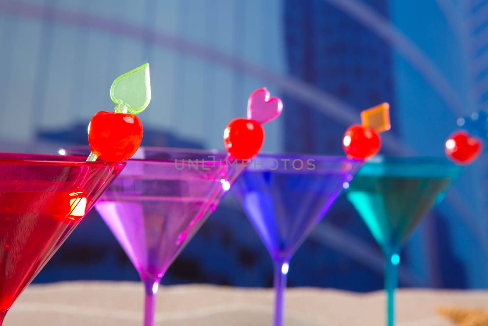 colorful cocktail in a row with cherry sand in urban city building