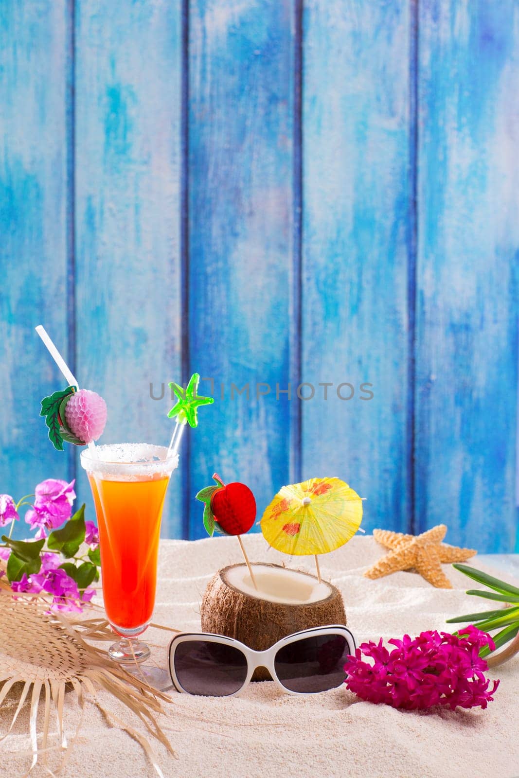 tropical cocktails on blue wood and sand sex on the beach and coconut