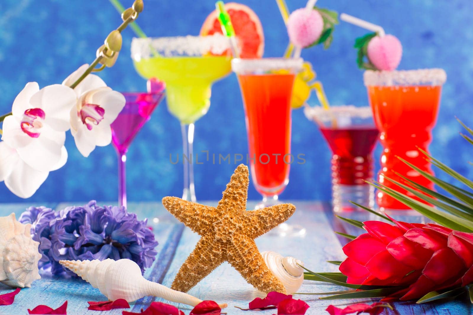 colorful mixed cocktails in tropical blue wood flowers starfish