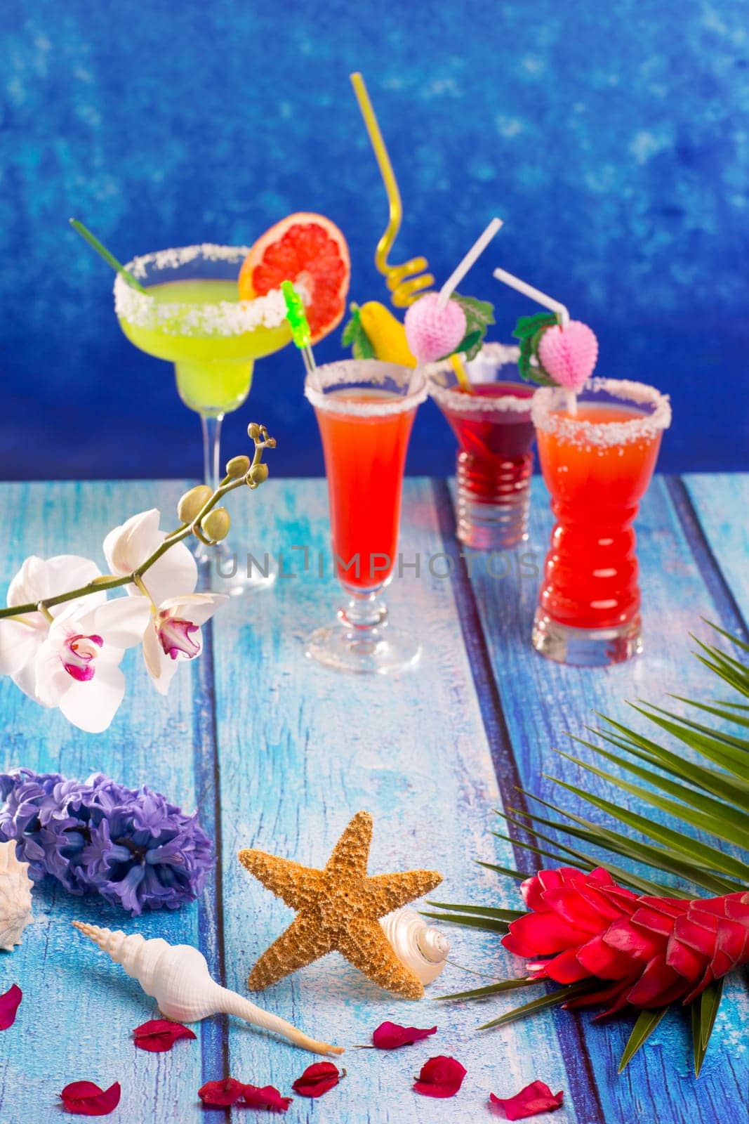 colorful mixed cocktails in tropical blue wood flowers starfish
