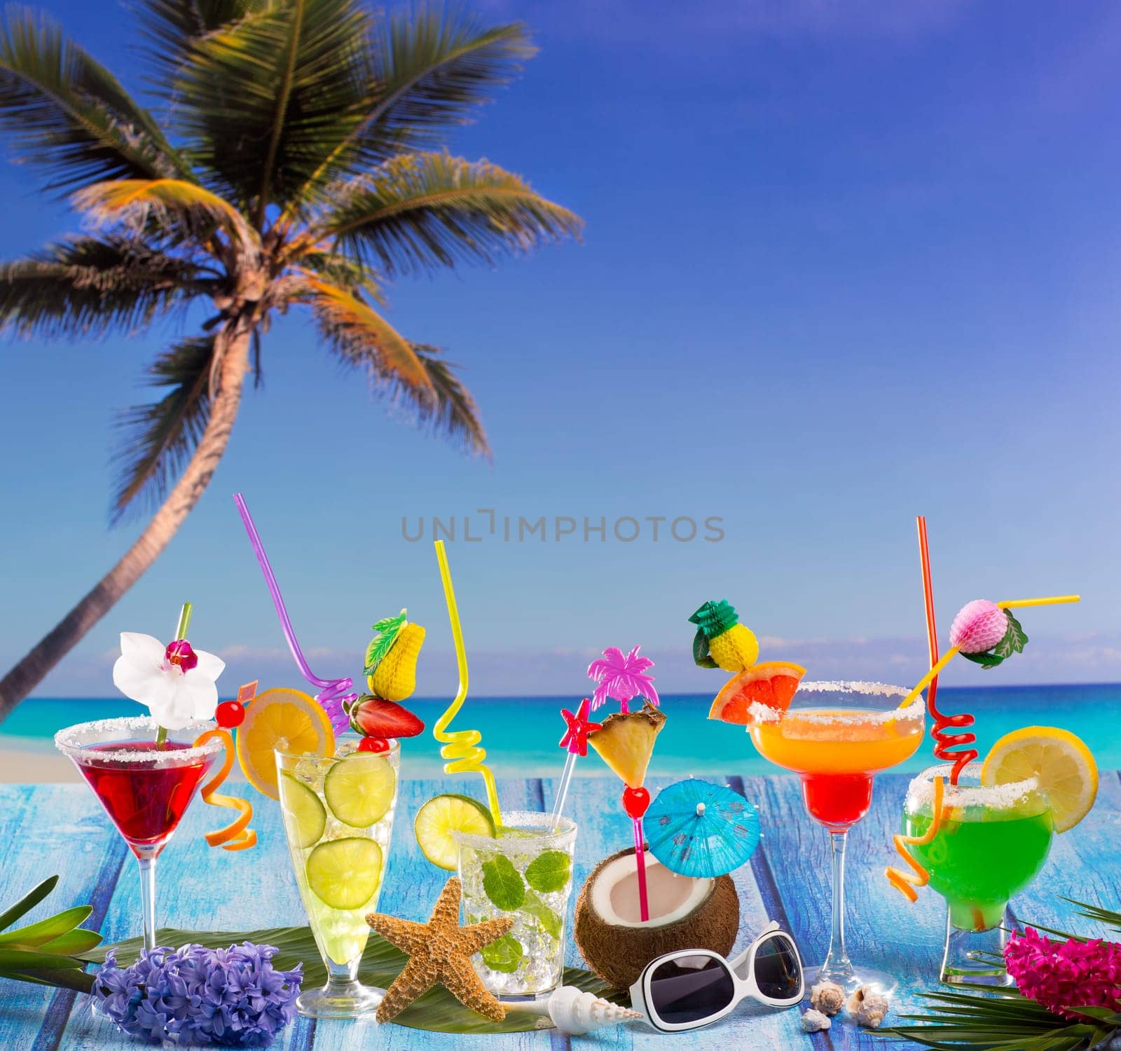 Beach colorful many tropical Cocktails in tropical blue wood with coconut mojito pepermint margarita and palm tree