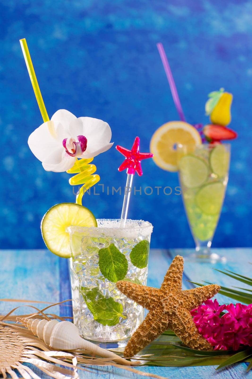 Mojito and lemon lime Cocktails in tropical Caribbean blue wood with starfish flowers and seashells