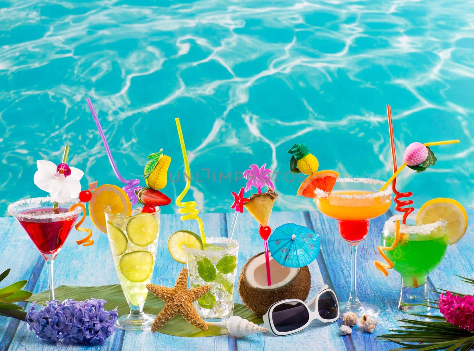 Colorful many tropical Cocktails in tropical blue wood at turquoise beach with coconut mojito margarita
