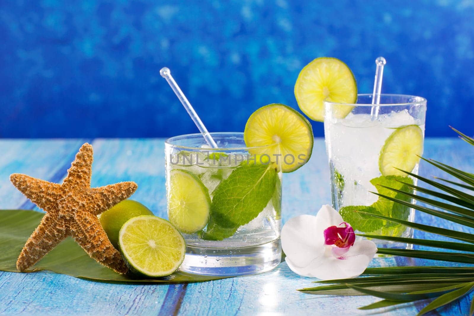 Cuban Mojito cocktail in tropical blue wood with flowers and starfish