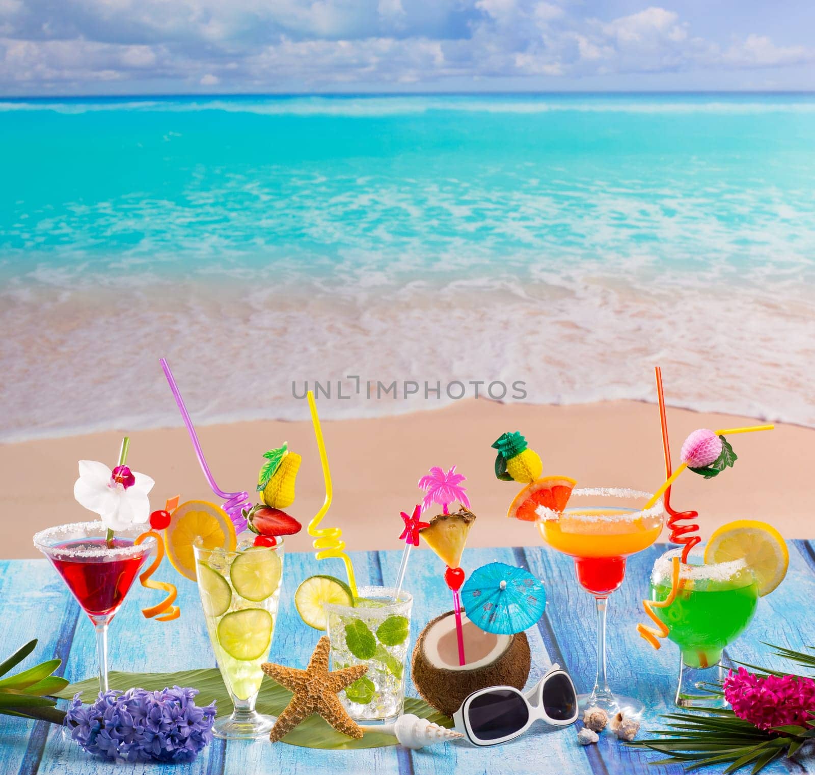 Colorful many tropical Cocktails in tropical blue wood at turquoise beach with coconut mojito margarita