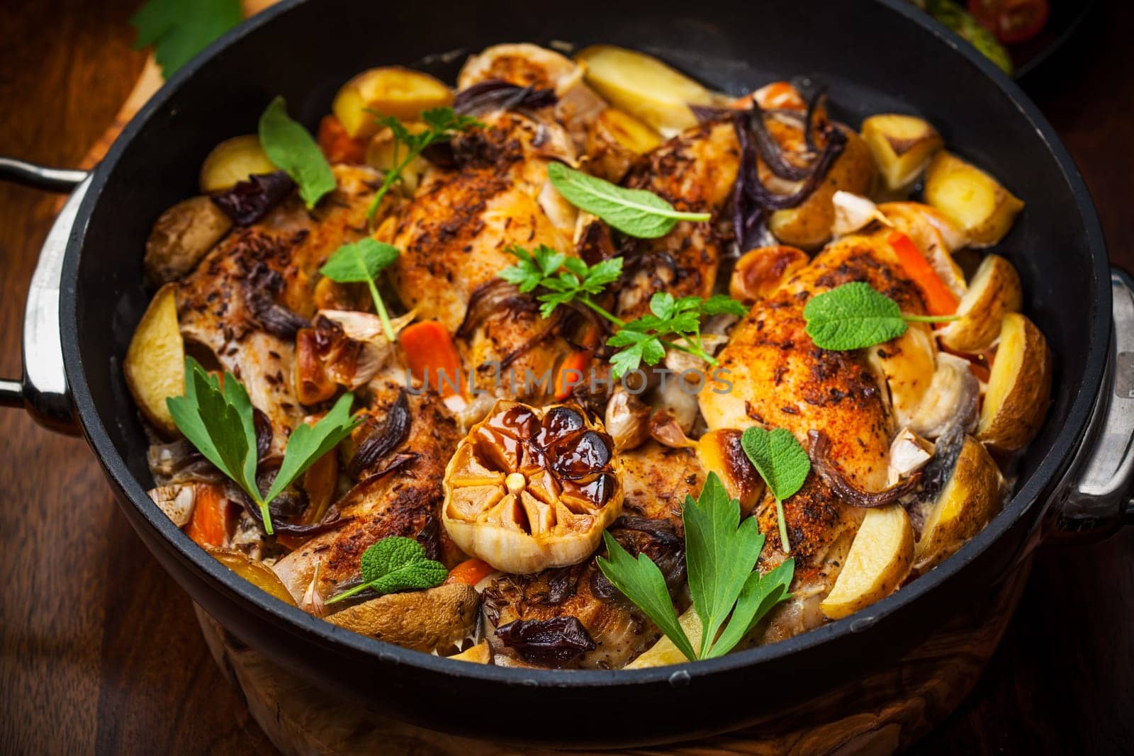 Roasted roasted rabbit on vegetables in pan