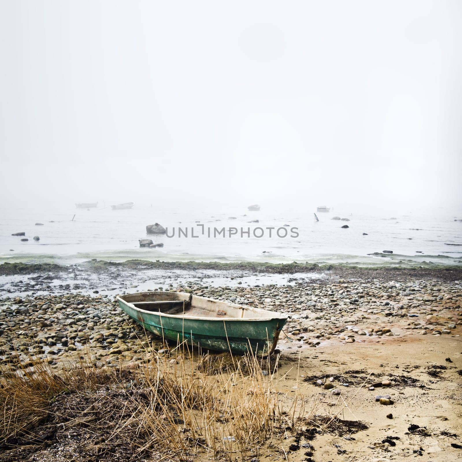 Old fishing boat at coast foggy in the morning