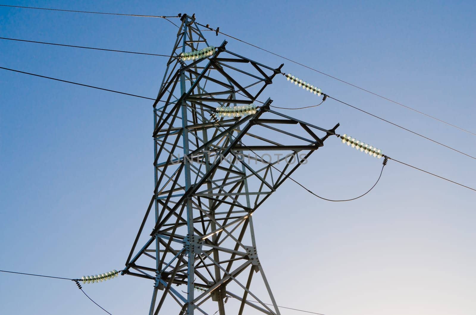High-voltage insulators on a pillar of an electric main