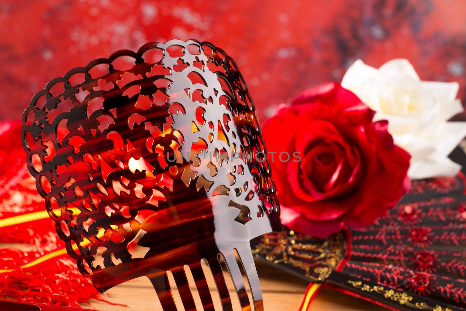 Flamenco comb fan and roses typical from Spain Espana on red background