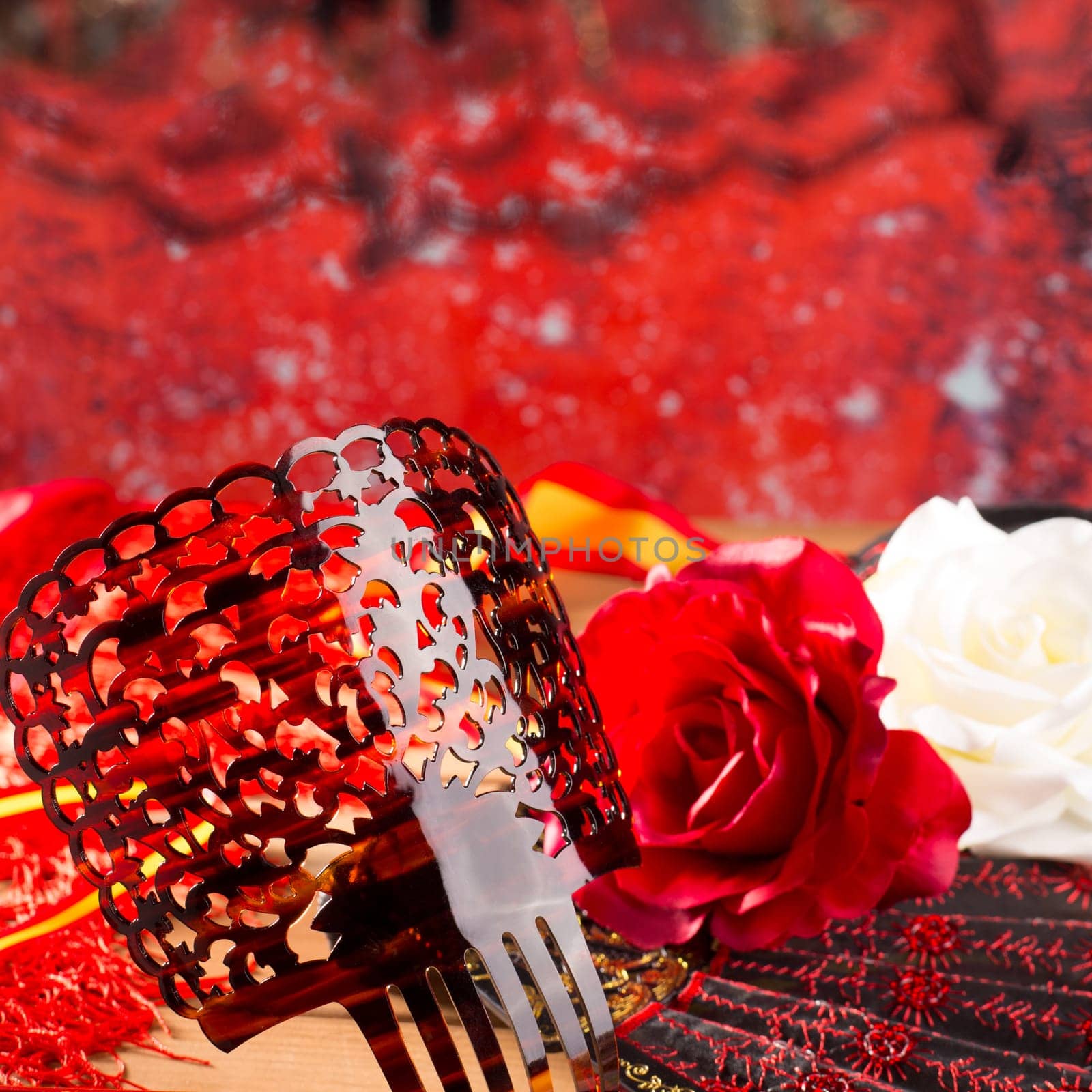 Flamenco comb fan and roses typical from Spain Espana on red background