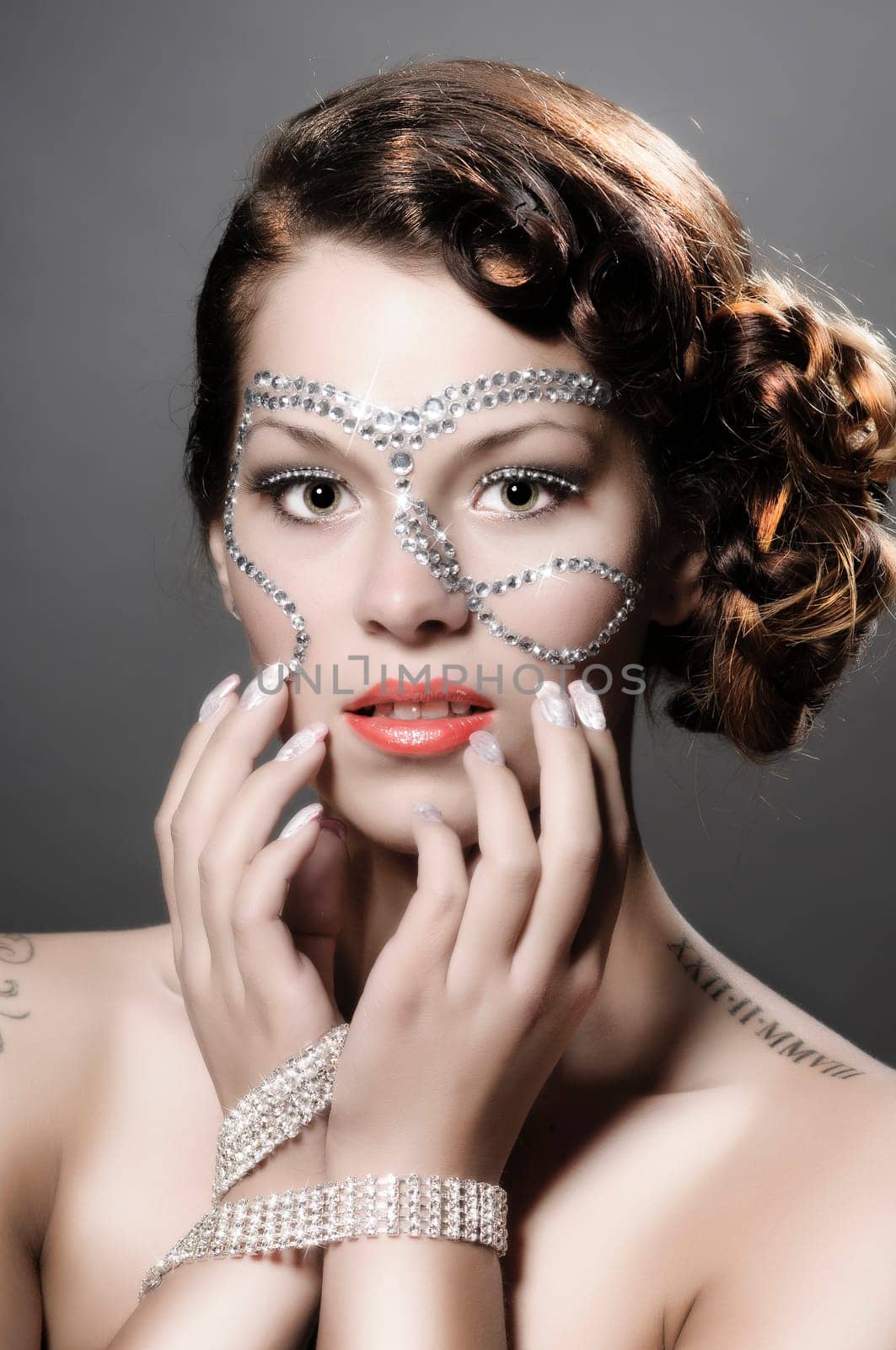 Portrait of a cute lady with diamonds and rhinestone-makeup.
