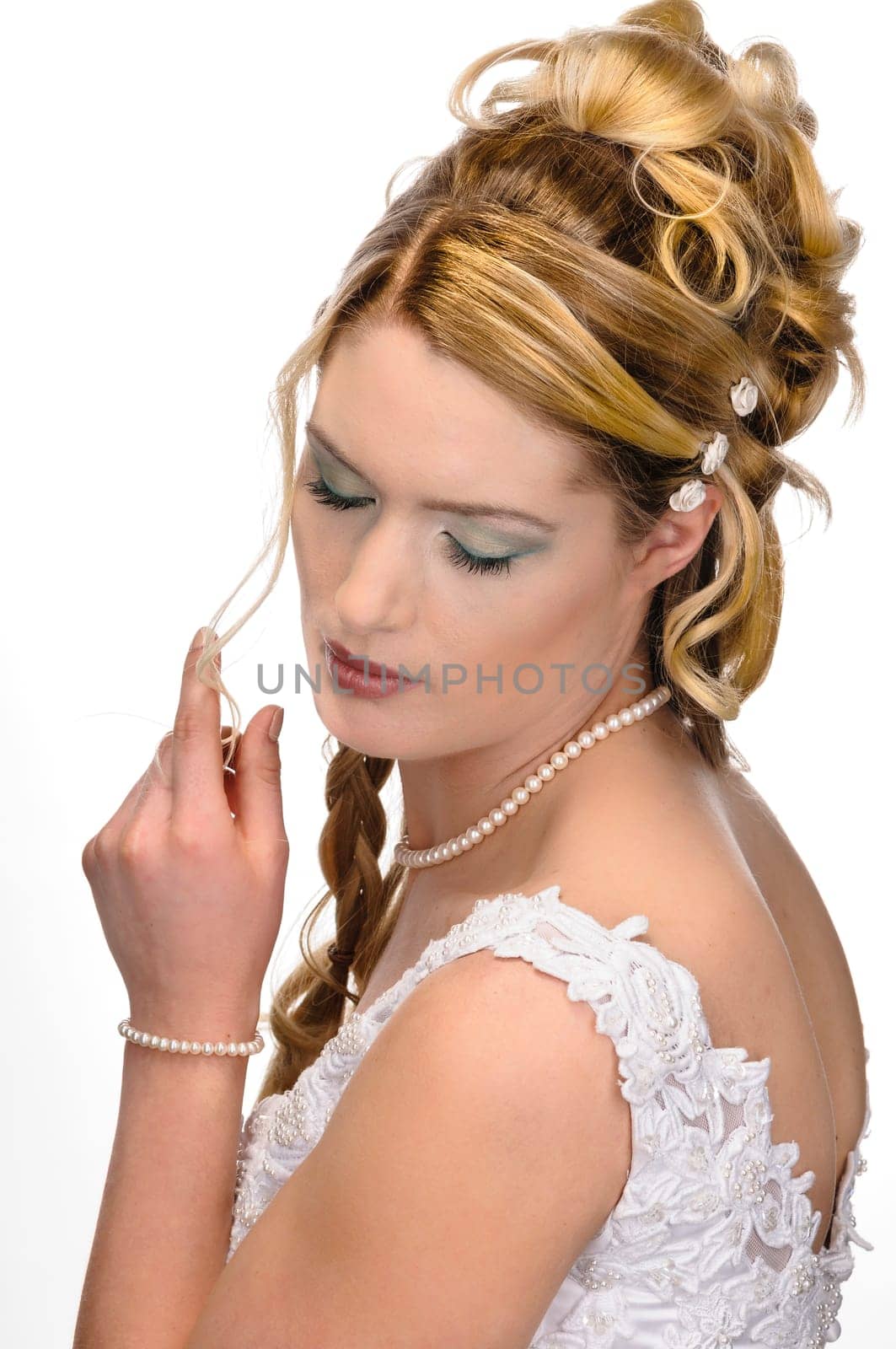 Portrait of a young bride with high hair und white bride dress.