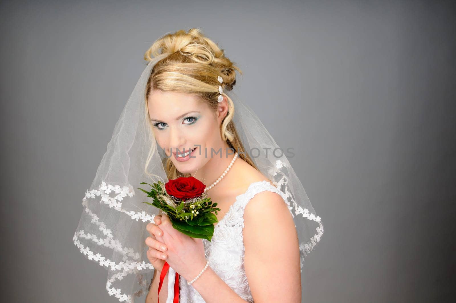 Portrait of a young bride with high hair und white bride dress.