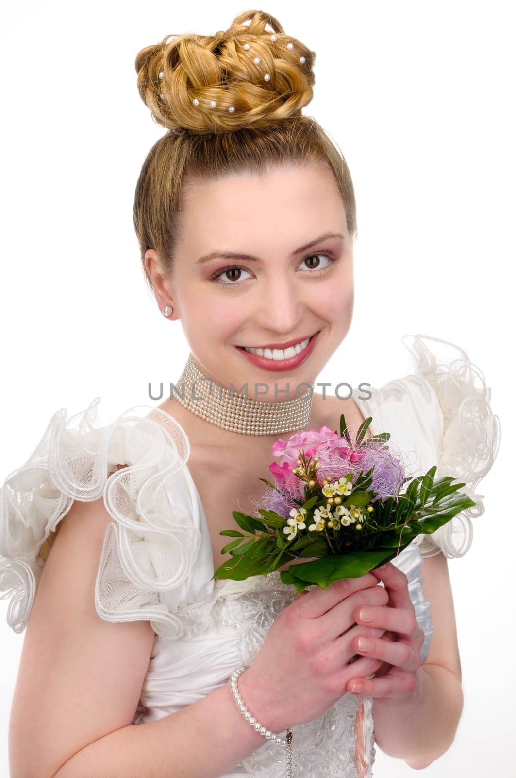 Portrait of a young bride with high hair und white bride dress, holding a flower bouquet.