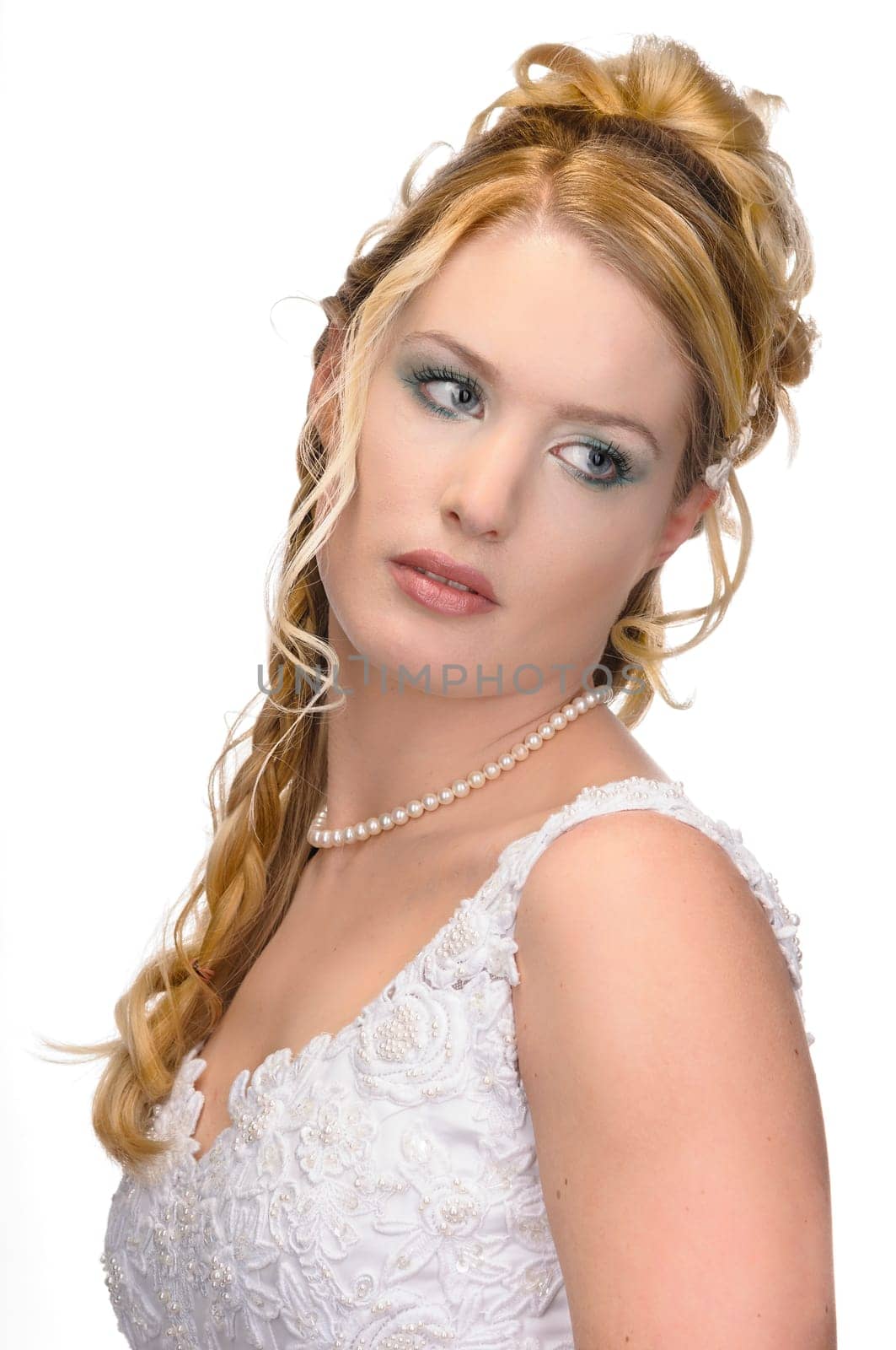 Portrait of a young bride with high hair und white bride dress.