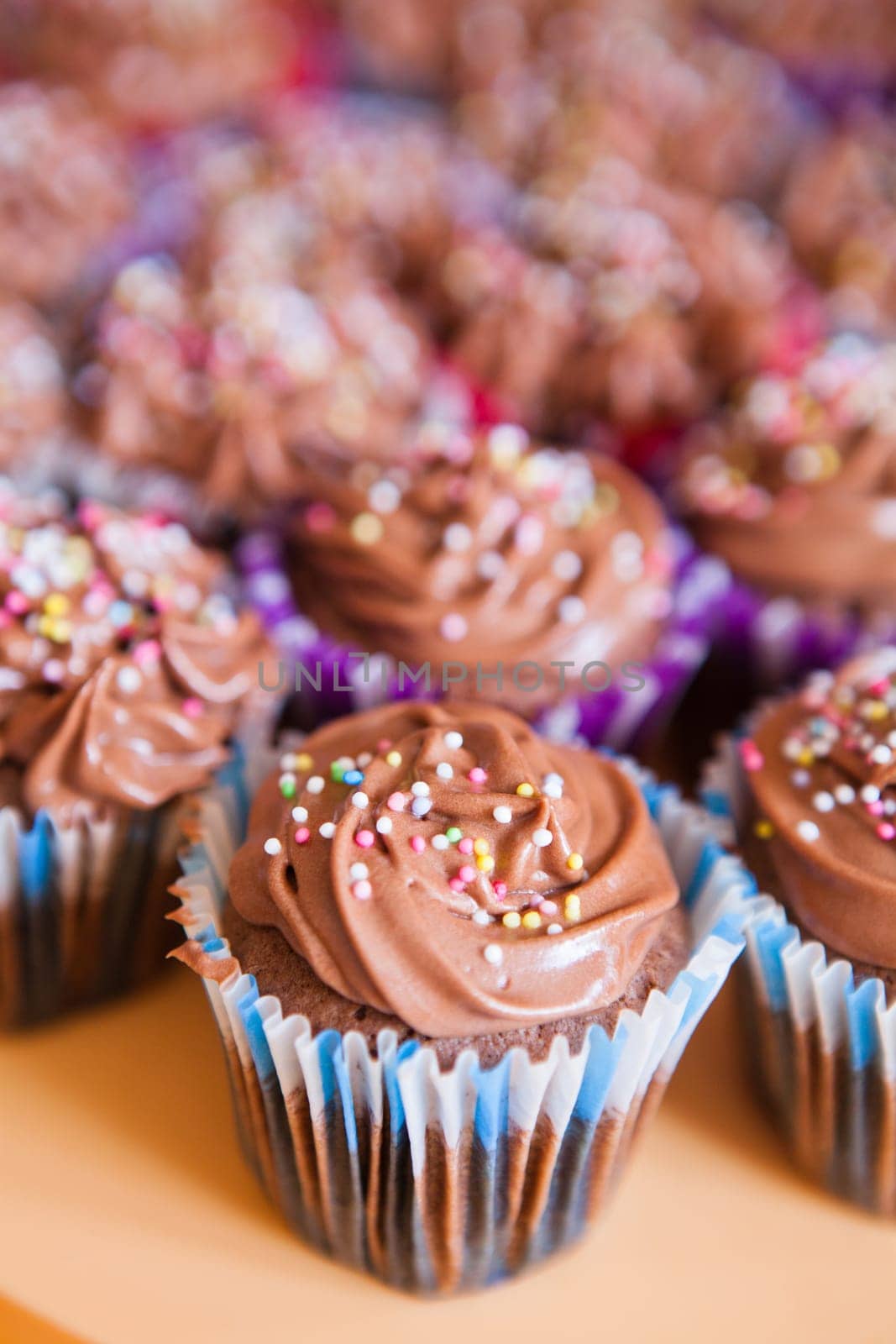 Closeup of chocolate cupcakes with decorative sprinkles