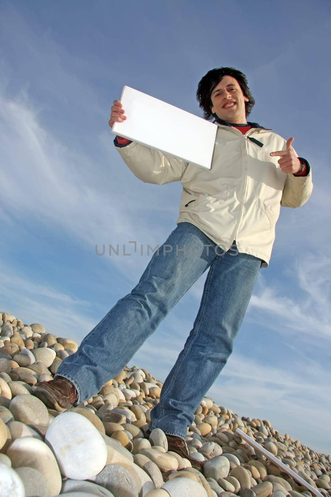 Man with empty card on beach