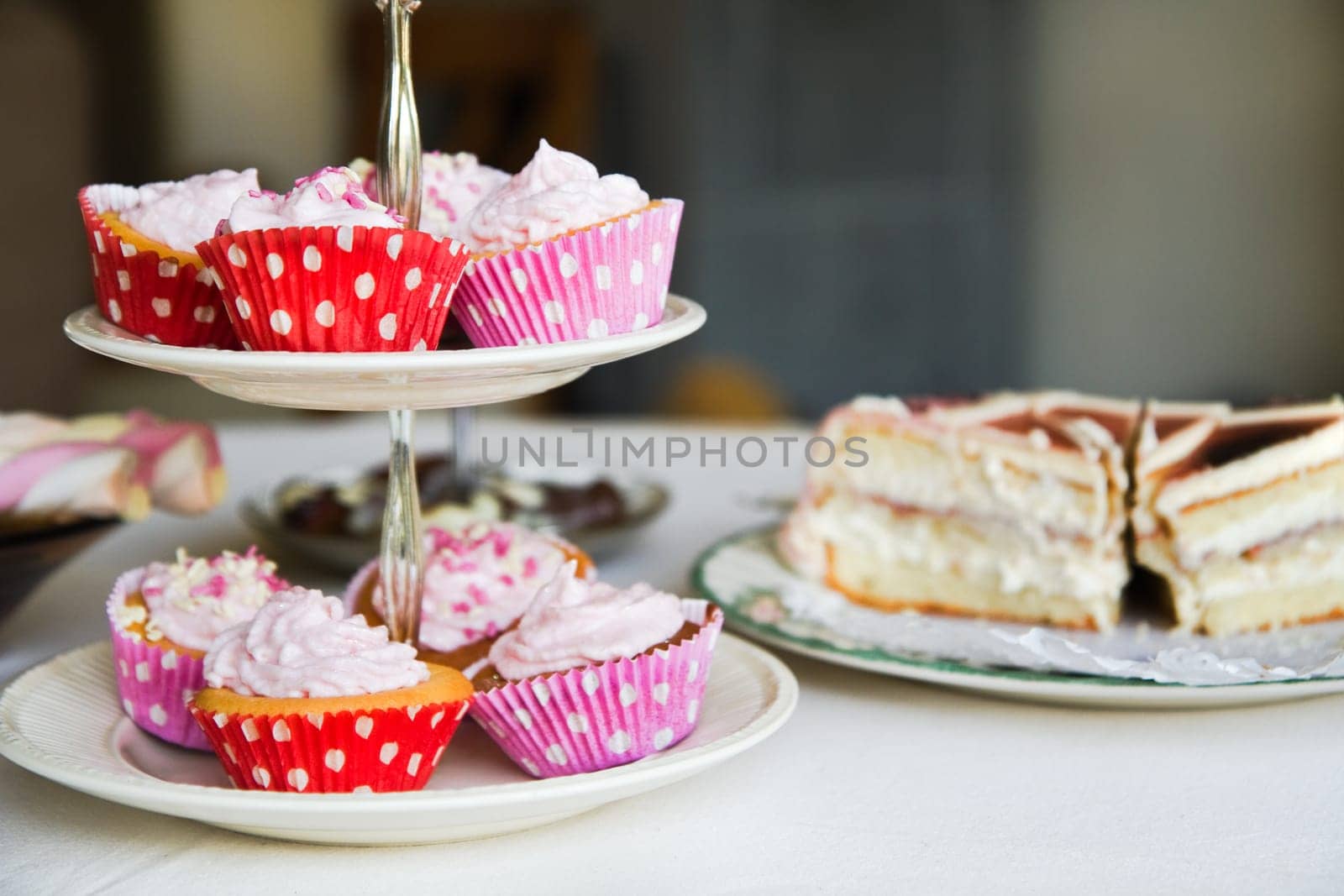 Cupcakes, birthday cake and other sweets on a table