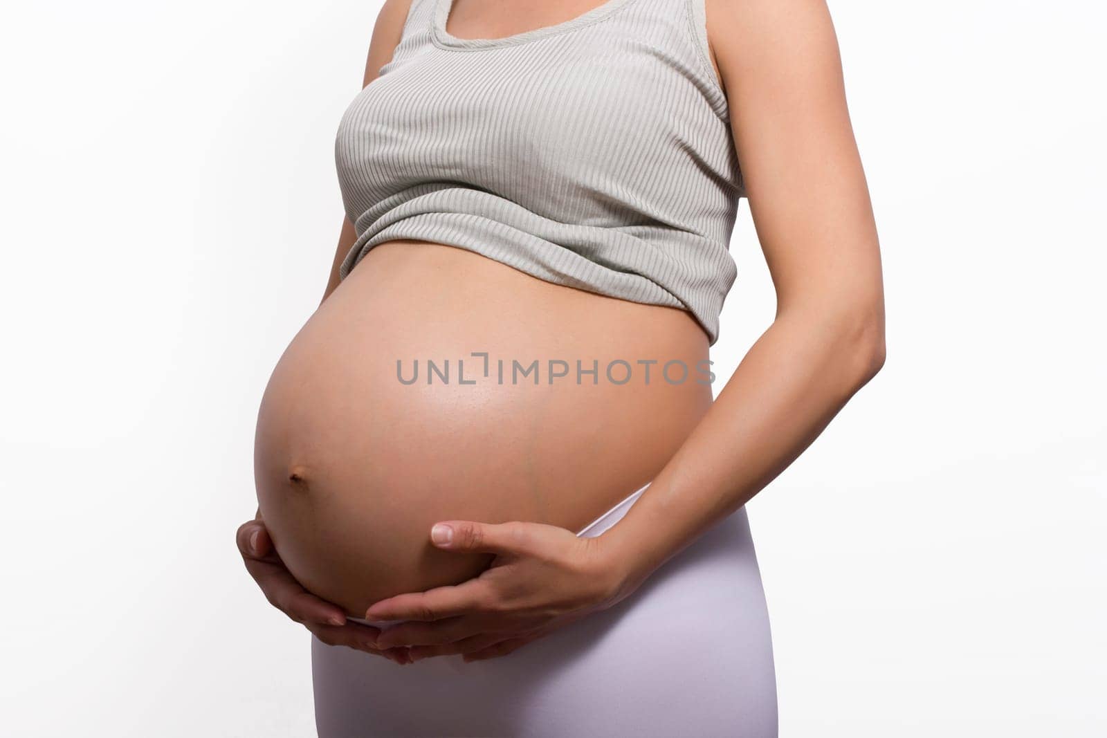 pregnant woman holding her big belly