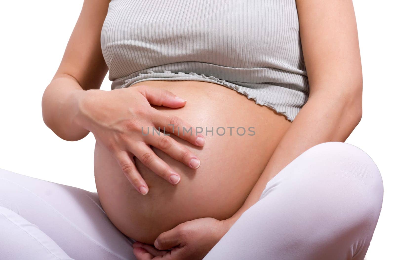 pregnant woman sitting with cross leg and touch her belly