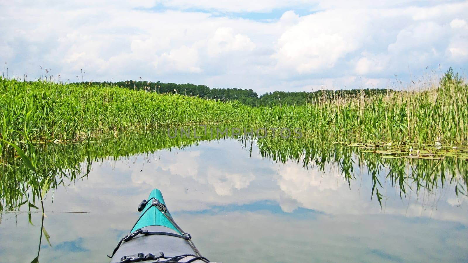 canoe on a river canal surrounded by reed