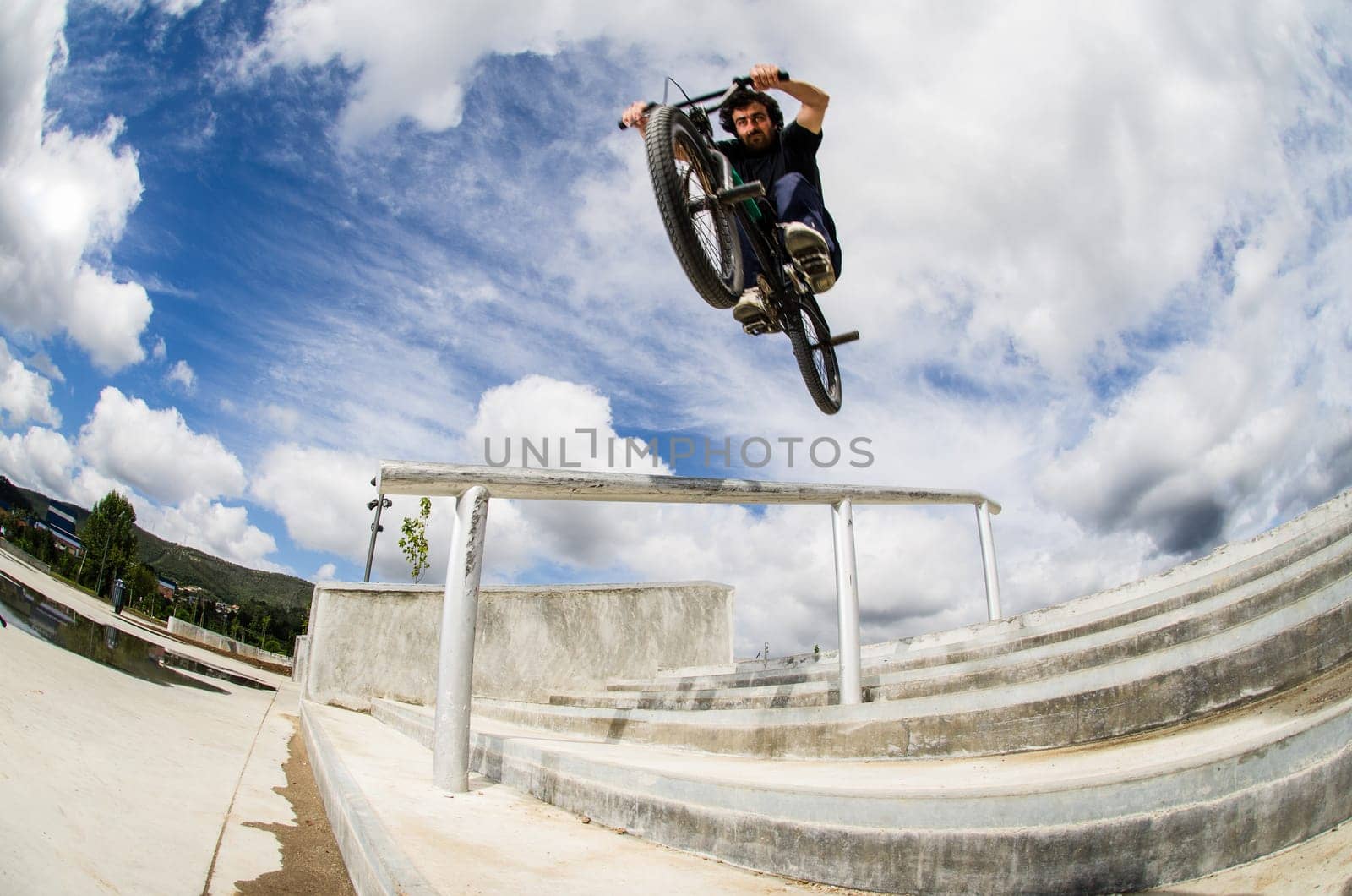 Bmx rider on a big air jump in a skate park.