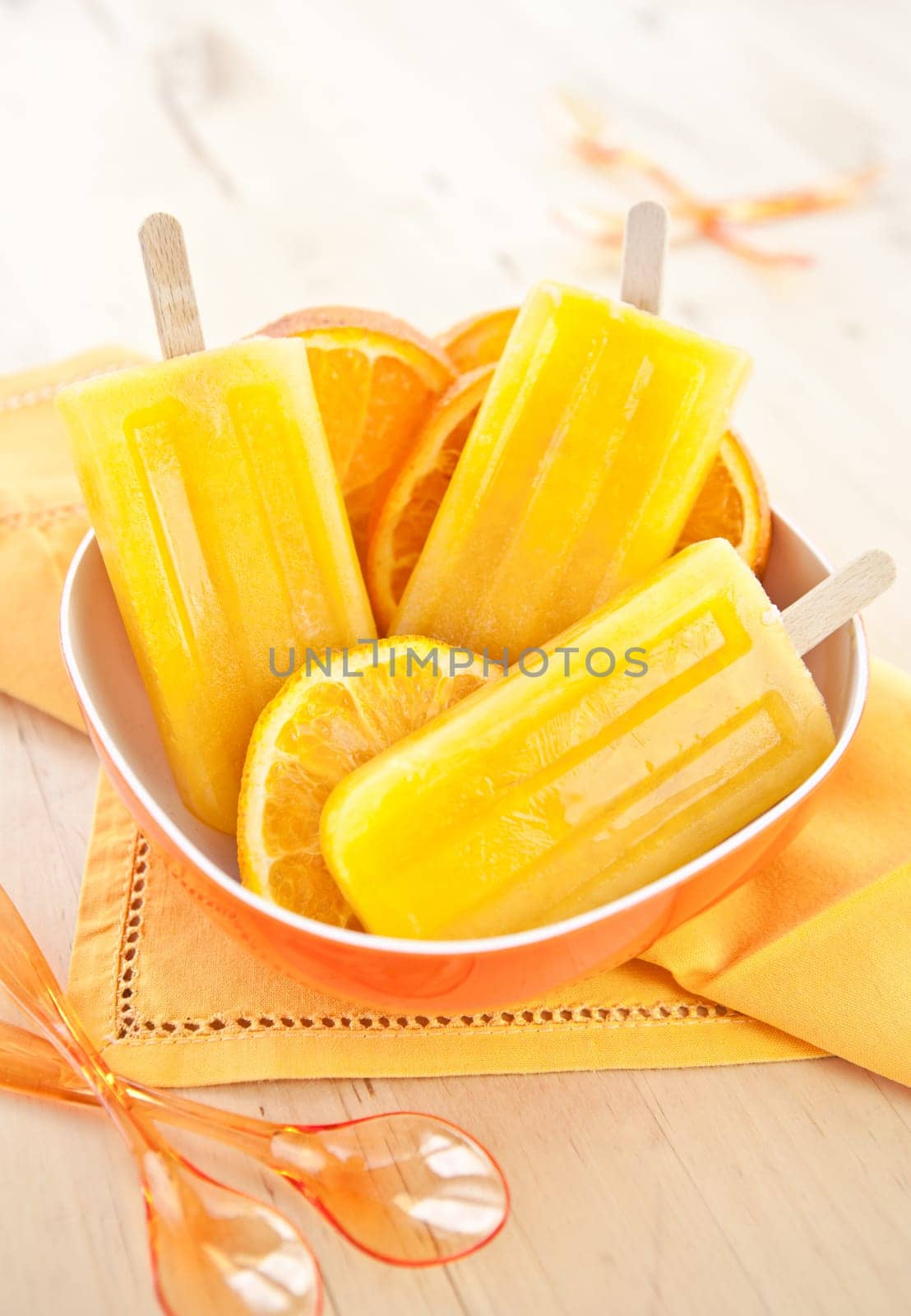 Homemade orange ice popsicles
