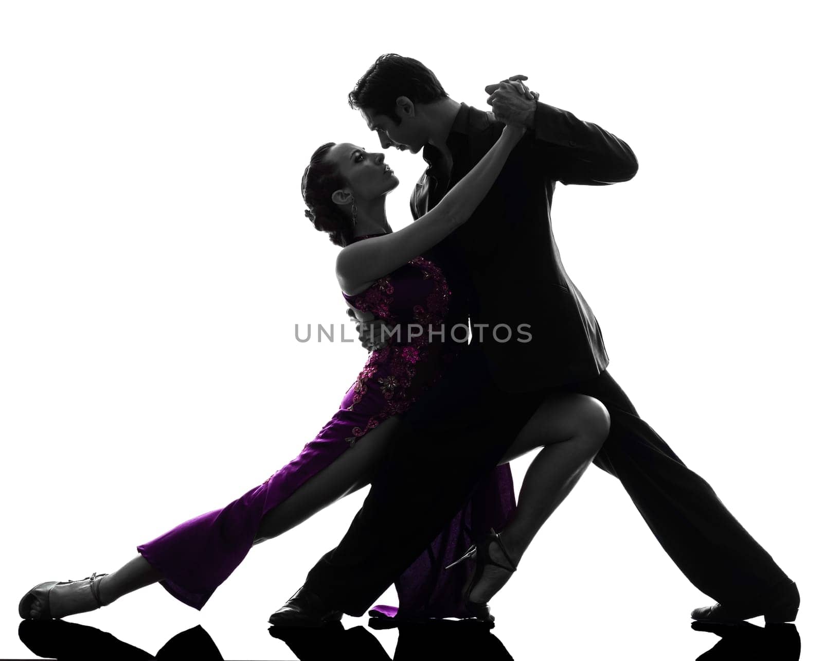 one caucasian couple man woman ballroom dancers tangoing  in silhouette studio isolated on white background