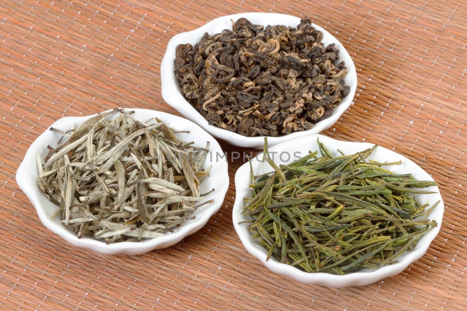 Chinese teas in plates on bamboo mat
